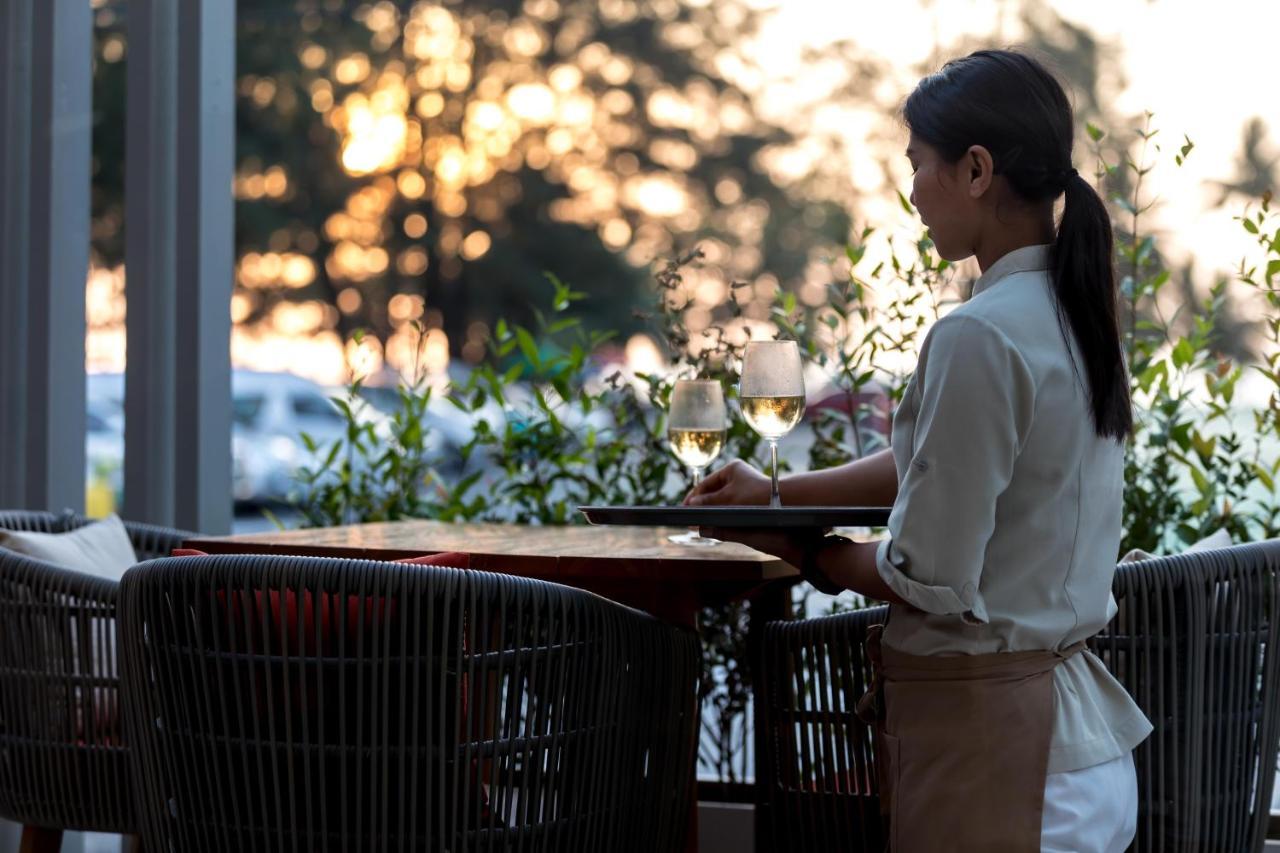 Outrigger Surin Beach Resort - Sha Extra Plus Eksteriør billede A waitress clearing a table